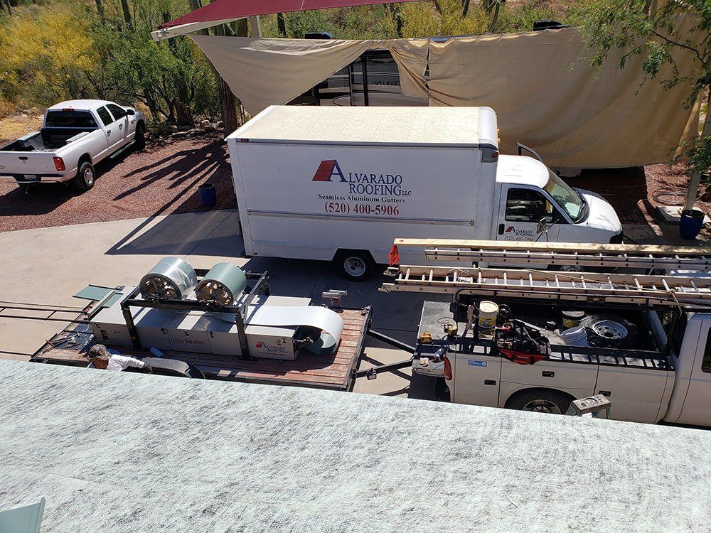 Trucks and installation materials parked near the site