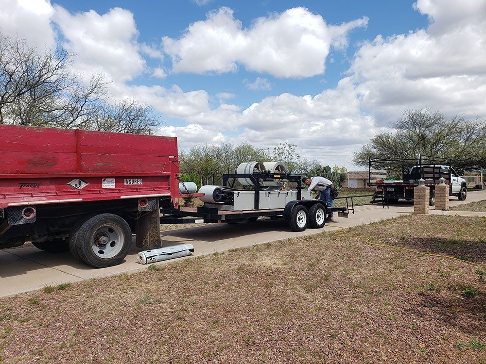 Trucks and installation materials parked near the site