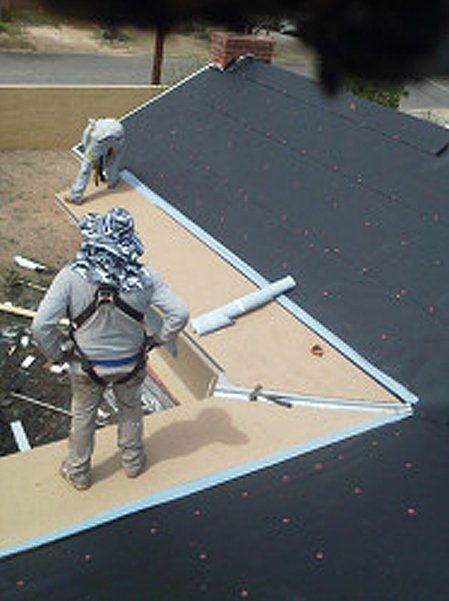 Two men installing roof