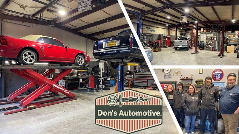 Automotive shop interior with cars on lifts, tools, and a team of people posing for a photo, Don's Automotive logo.