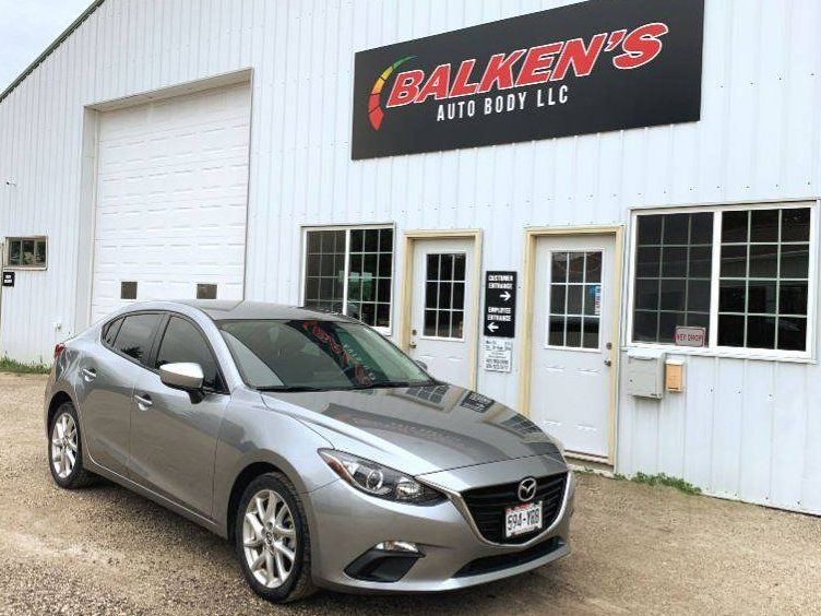 Silver car in front of the shop