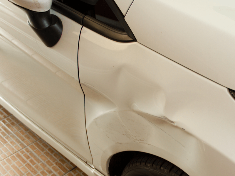 Dented white car