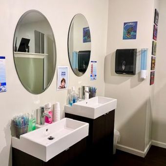 A bathroom with two sinks and two mirrors.