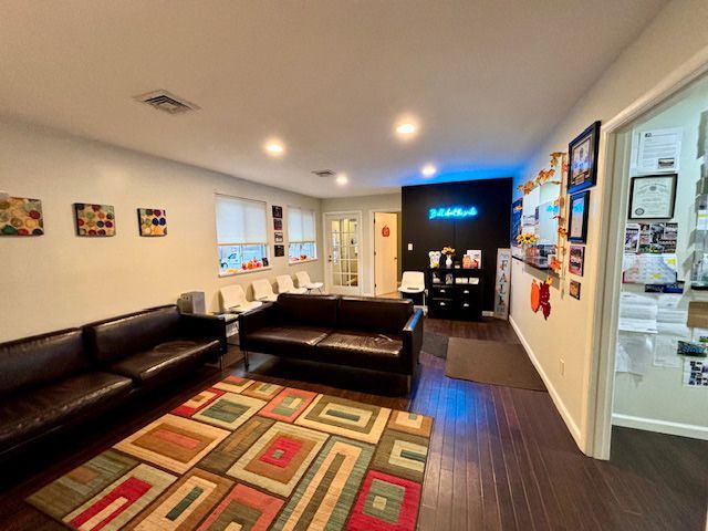 A living room with a couch and a rug