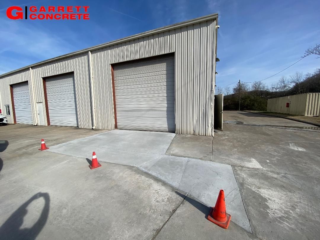 a concrete walkway is being built in front of a garage