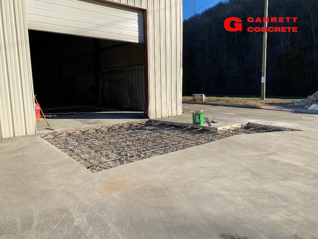 a concrete driveway is being built in front of a garage
