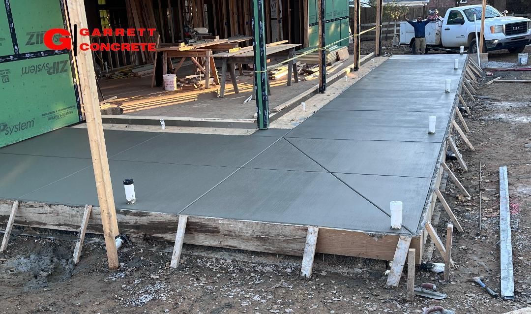 a concrete walkway is being built in front of a building under construction