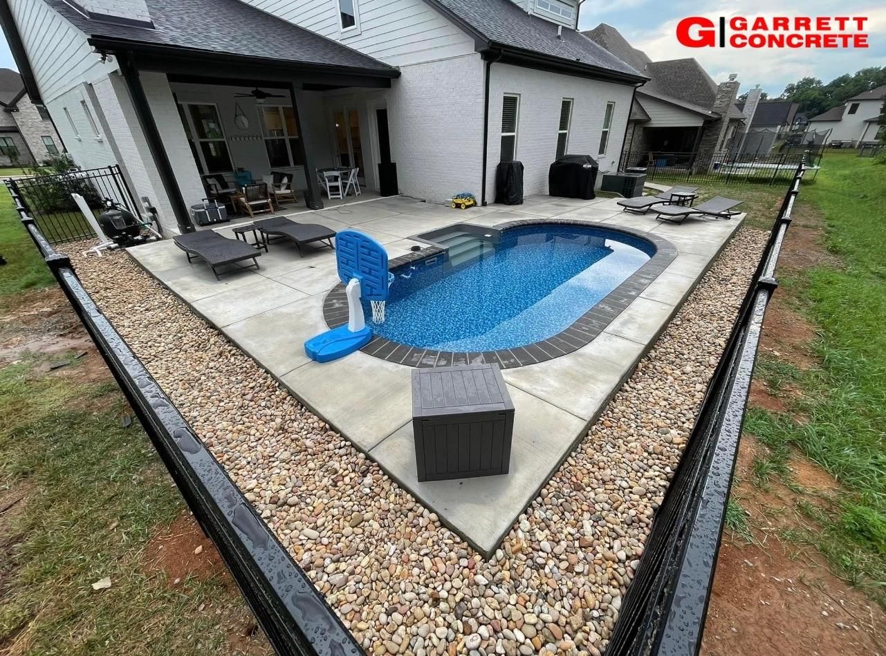 a large swimming pool is in the backyard of a house