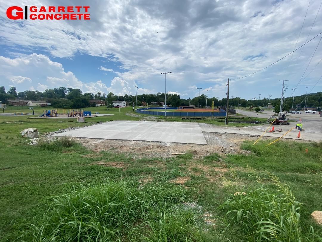 a large concrete slab is sitting in the middle of a grassy field