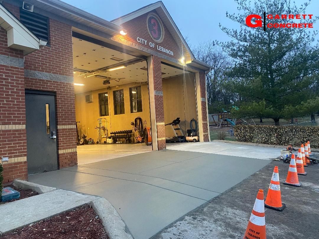 a fire station with a concrete driveway in front of it