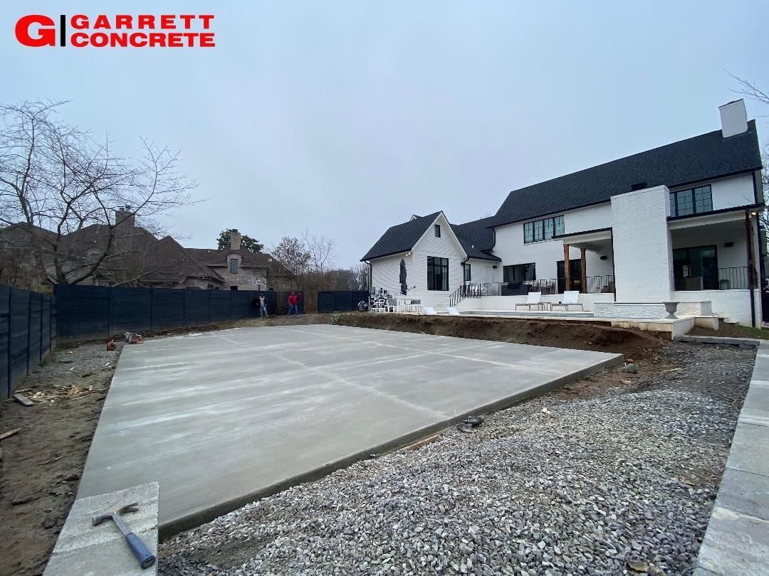 a concrete driveway is being built in front of a house