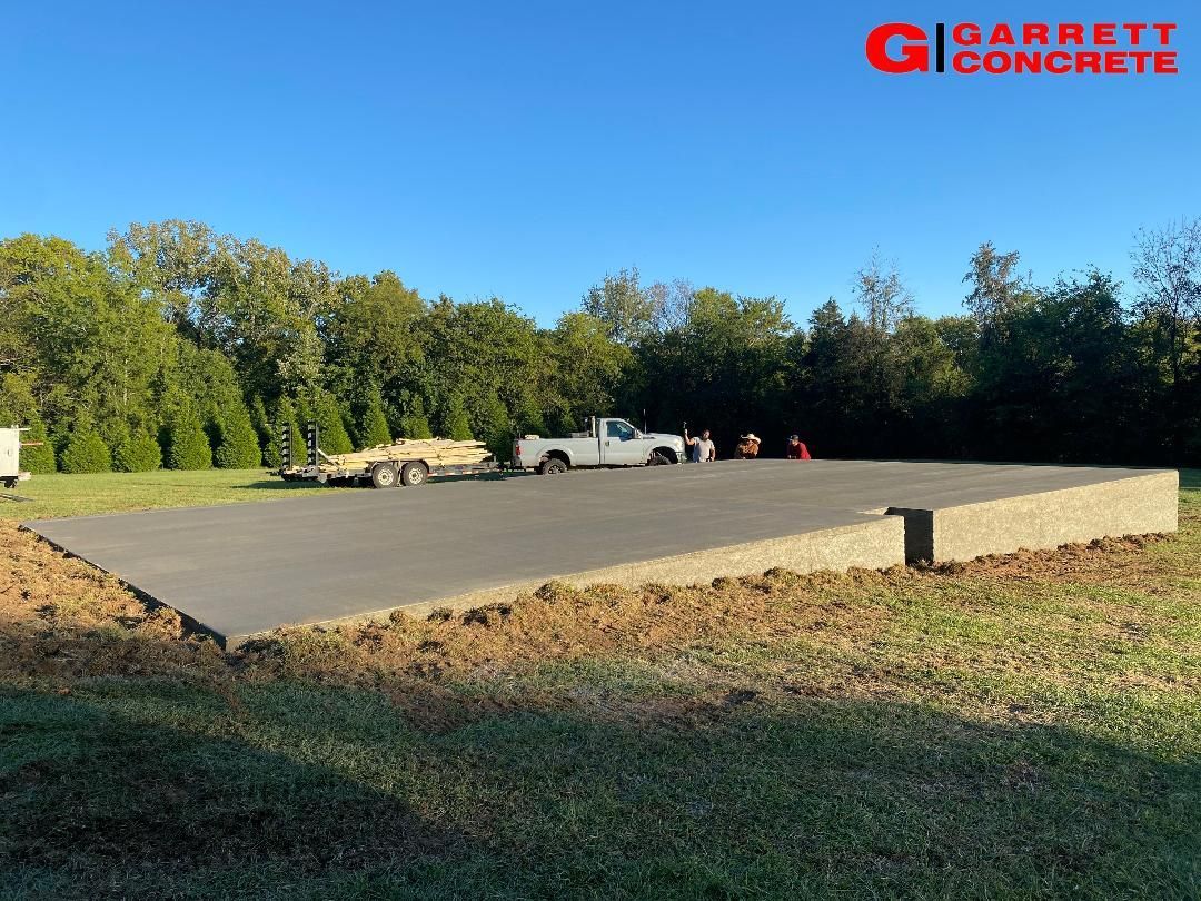 a concrete driveway with a truck parked in the middle of it