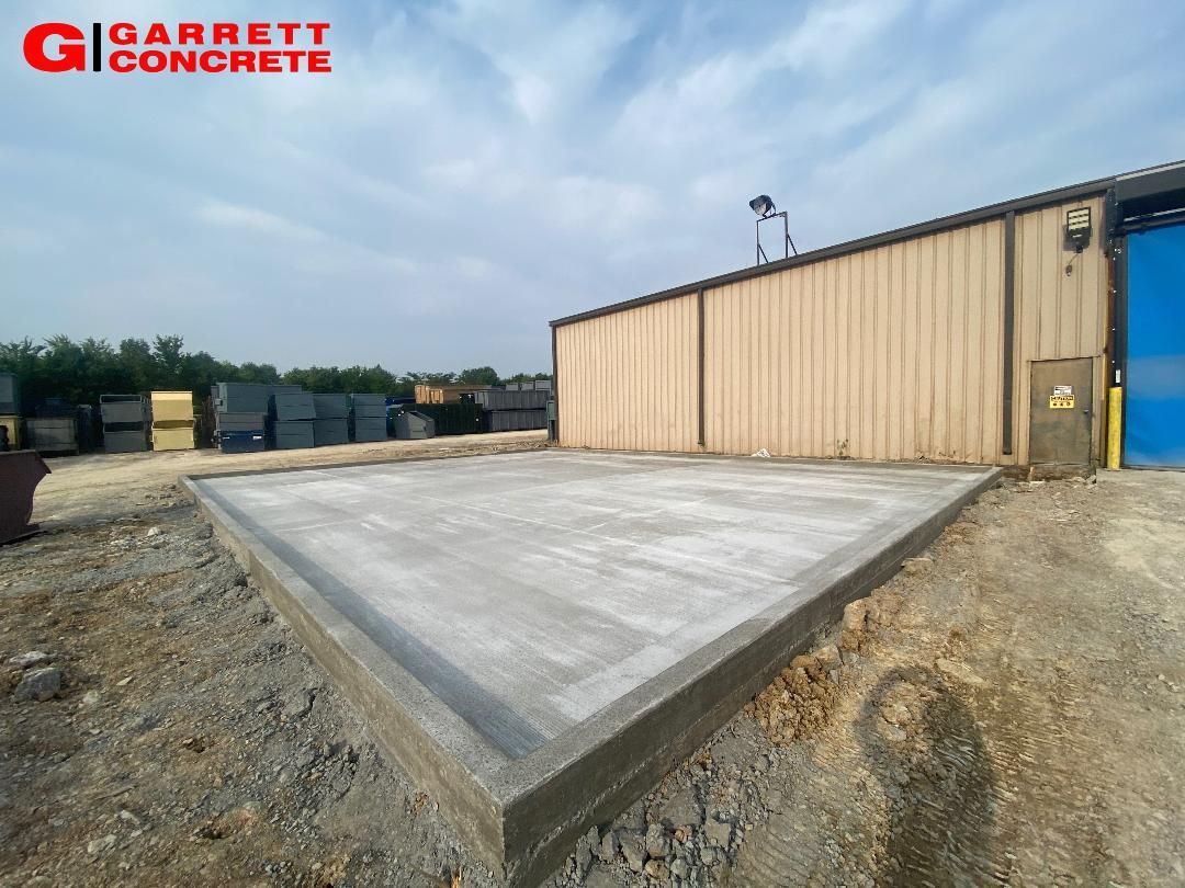 a large concrete slab in front of a building