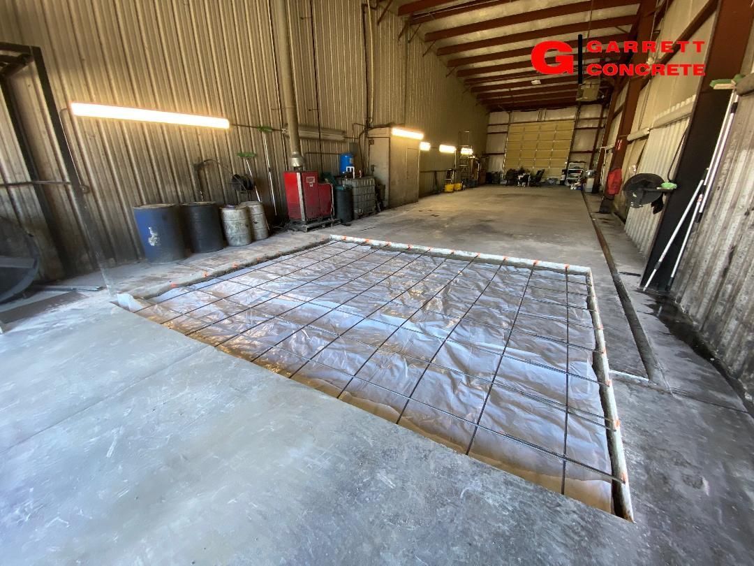a large concrete floor is being built in a warehouse