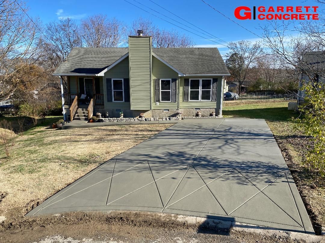 a house with a concrete driveway in front of it
