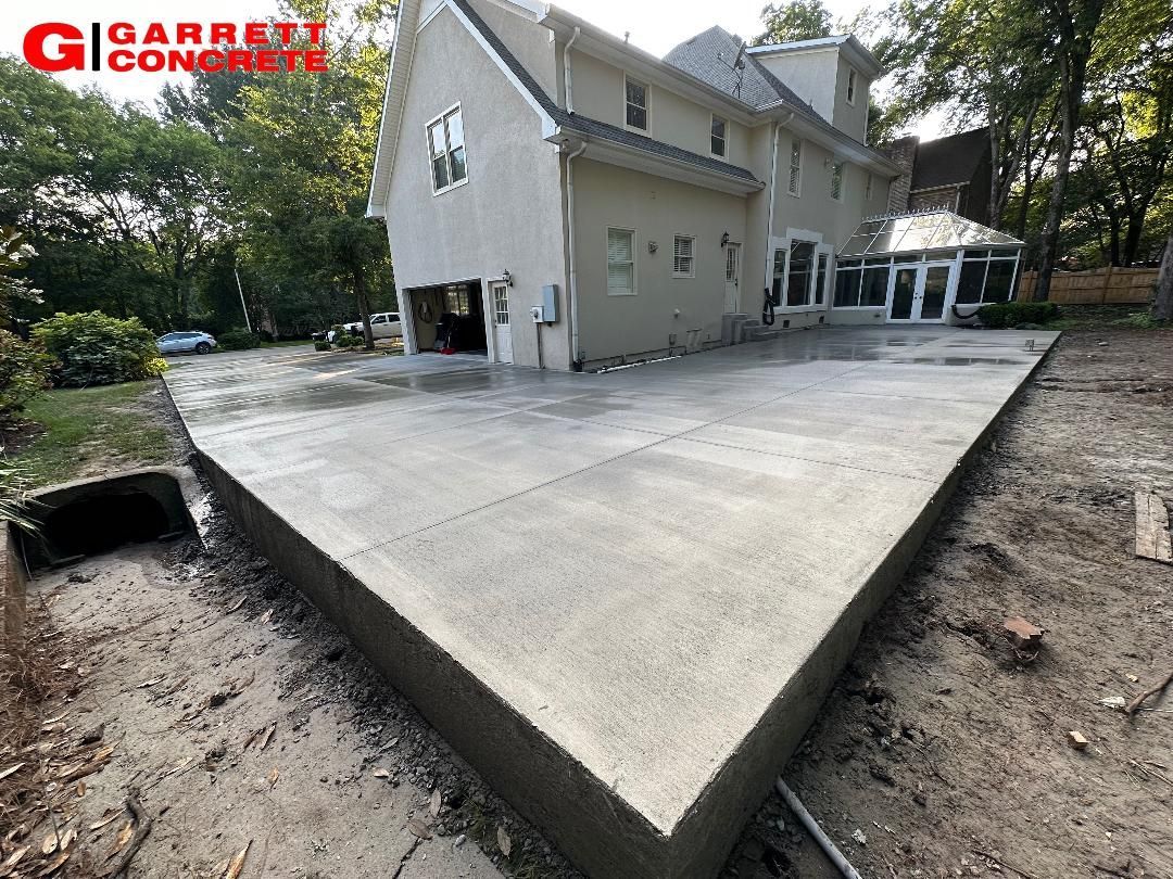 a large house with a concrete driveway in front of it