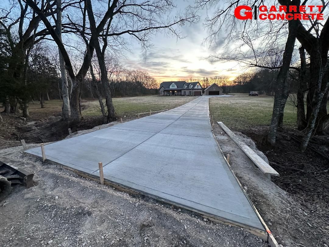 a concrete driveway is being built in front of a house