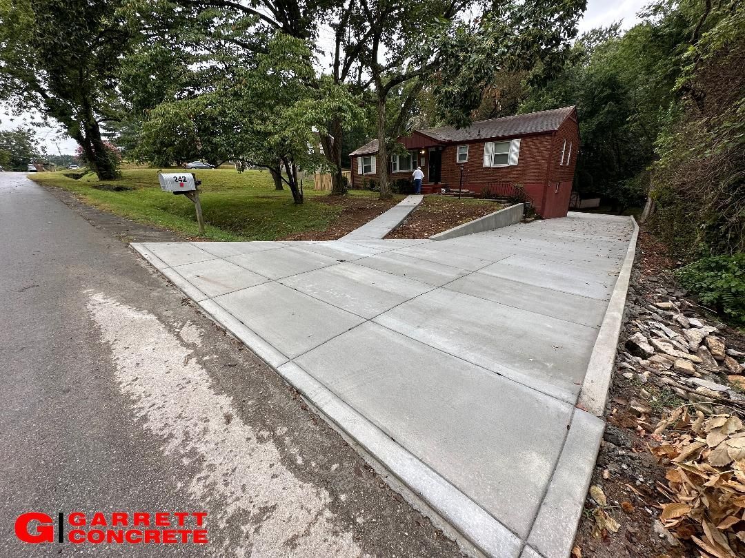 a concrete driveway is being built in front of a house