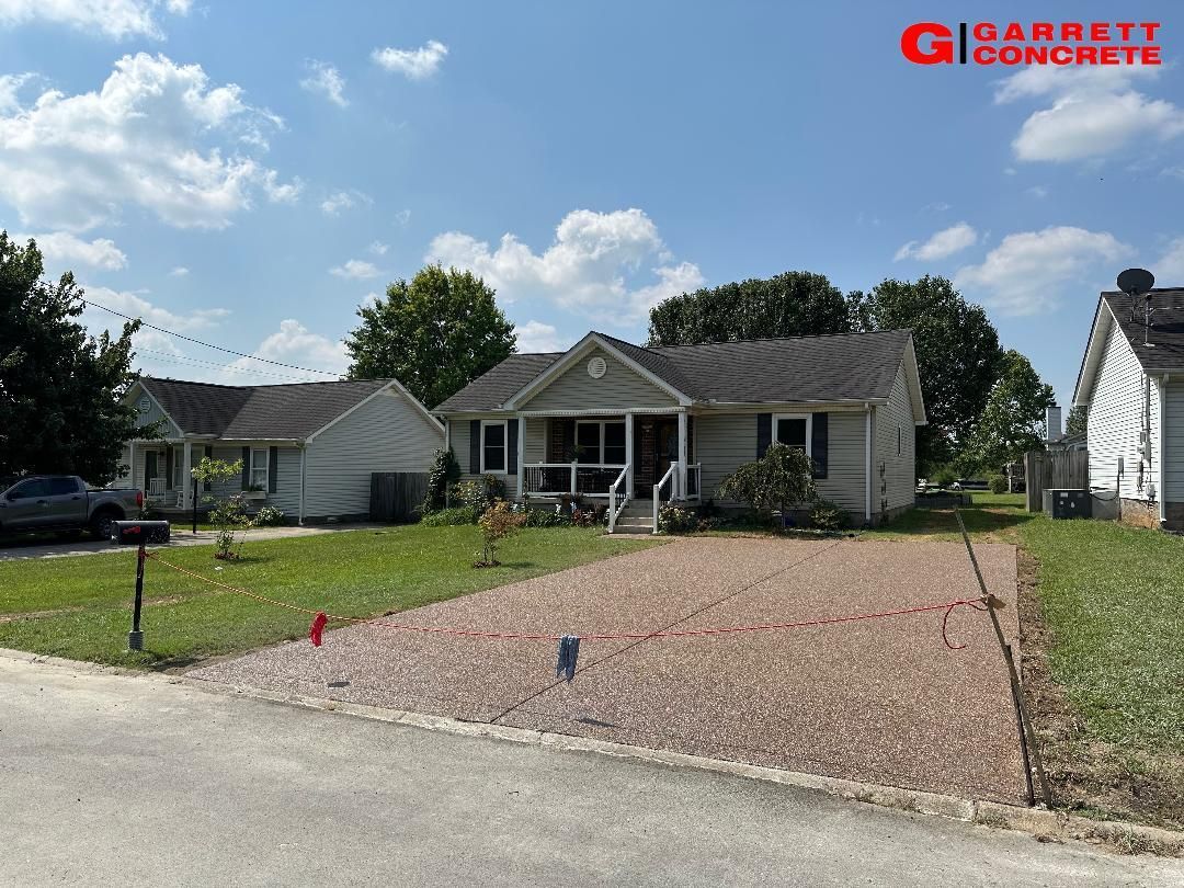 a house with a gravel driveway in front of it
