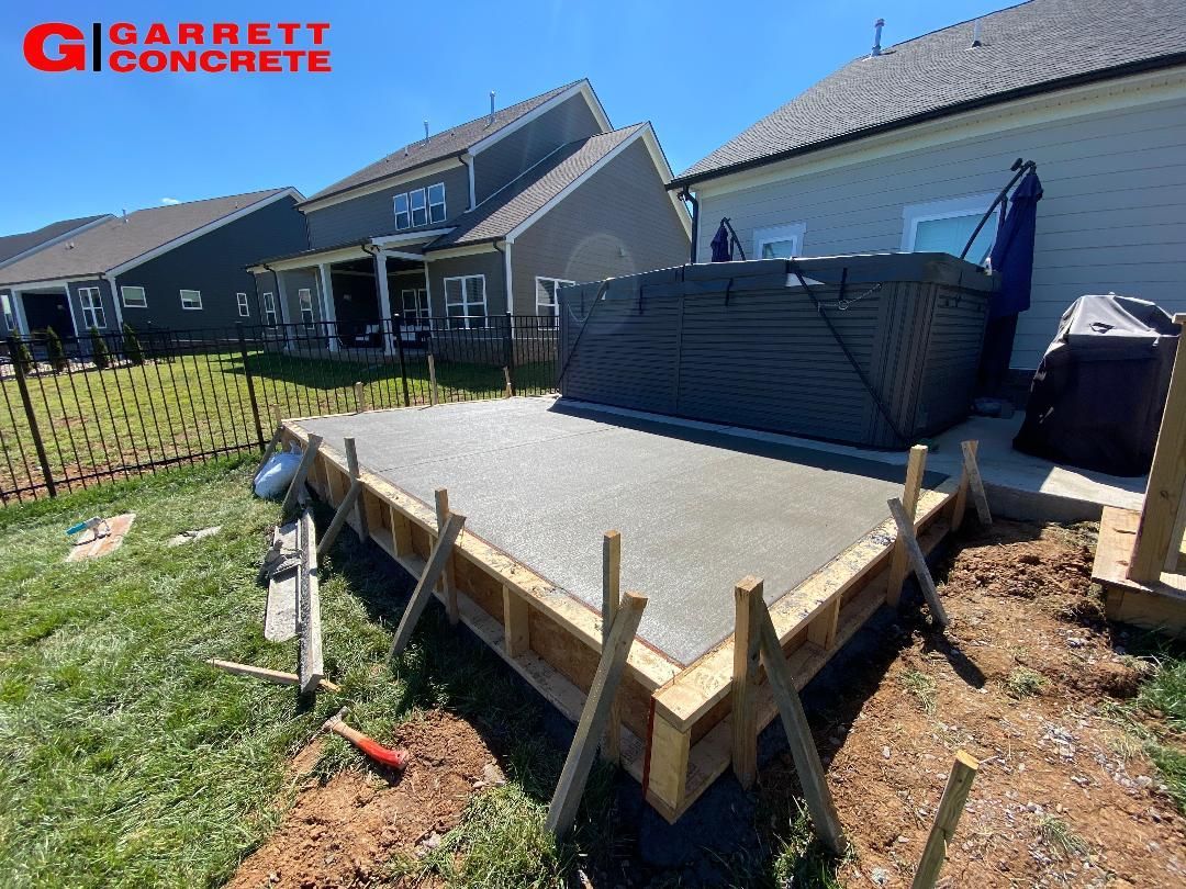 a concrete patio is being built in front of a house