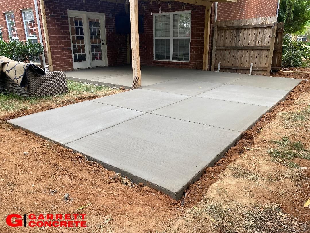 a concrete patio is being built in the backyard of a house