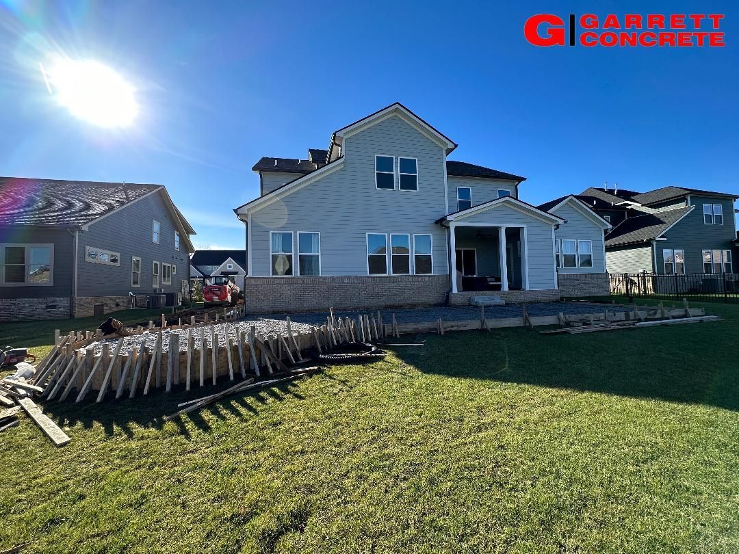 a large white house is sitting on top of a lush green lawn