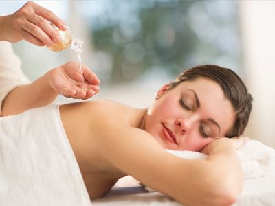 A woman is getting a massage at a spa .