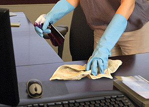 Woman cleaning office desk