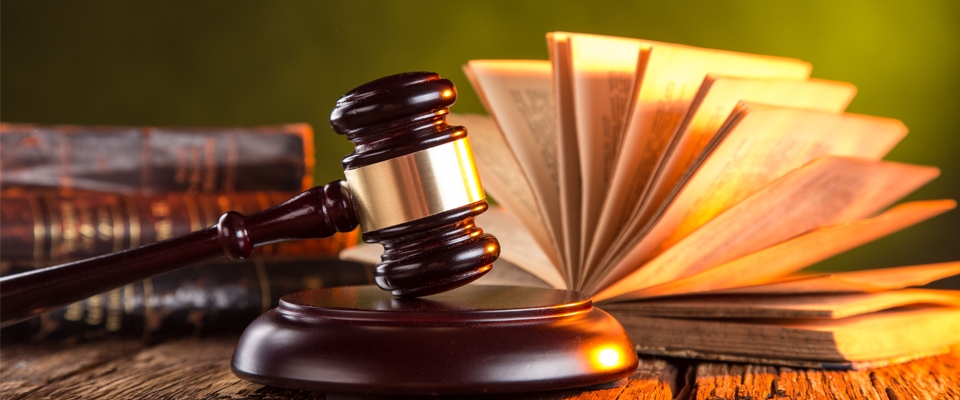 Wooden gavel and books on wooden table