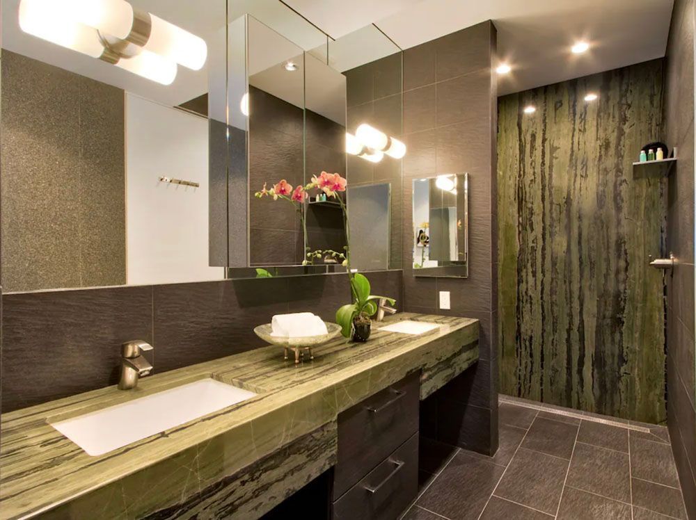 A bathroom with two sinks and a large mirror