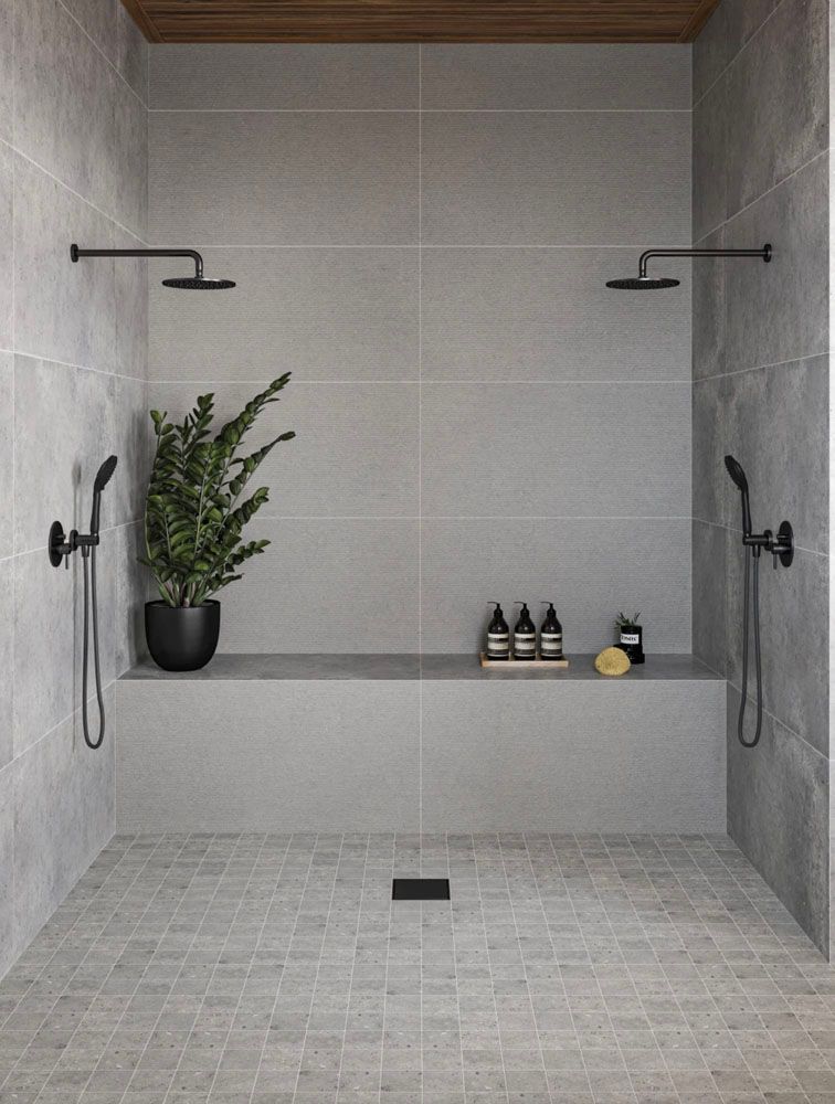 A bathroom with two showers 