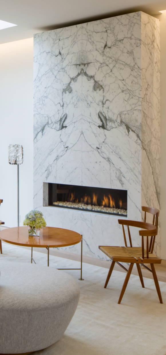 a fireplace and a marble wall