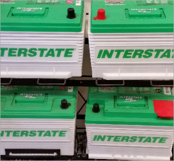 Four interstate batteries are stacked on top of each other