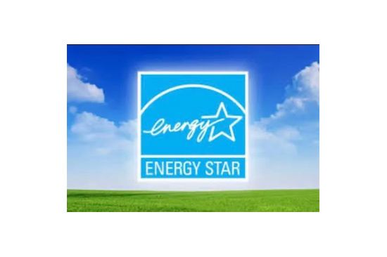 Blue Energy Star logo on a sunny day with a green field and blue sky.