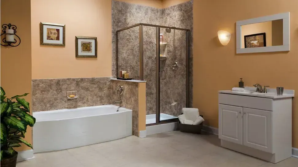 Modern bathroom with bathtub, glass shower, and white vanity in beige and stone tones