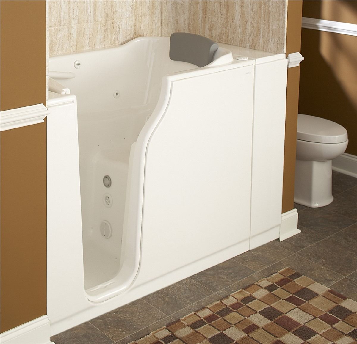 Walk-in bathtub with built-in door beside a toilet in a bathroom