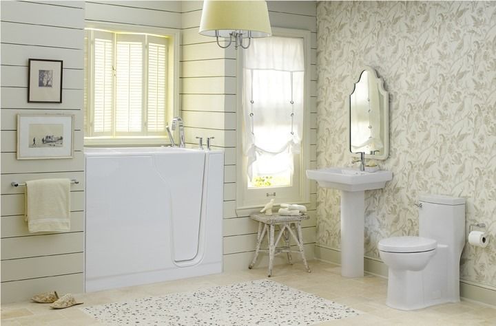 Bright white bathroom with clawfoot tub, pedestal sink, toilet, mirror, and window with shutters.