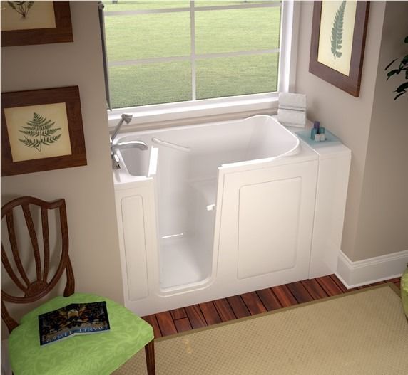 Bathroom with a white walk-in tub by a window, surrounded by wood trim and green accents