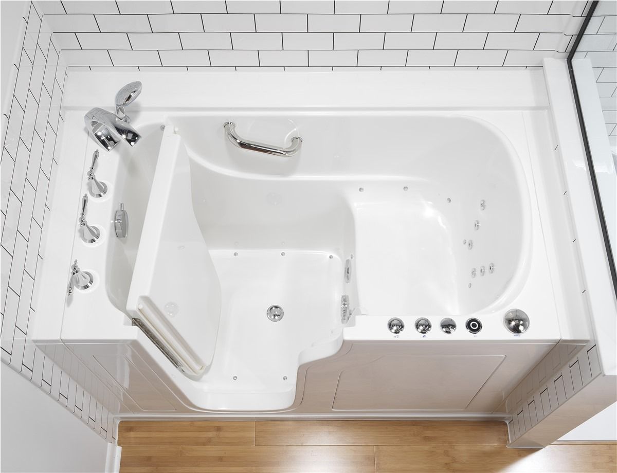 White corner walk-in bathtub with built-in seat, grab bars, and jets in a tiled bathroom