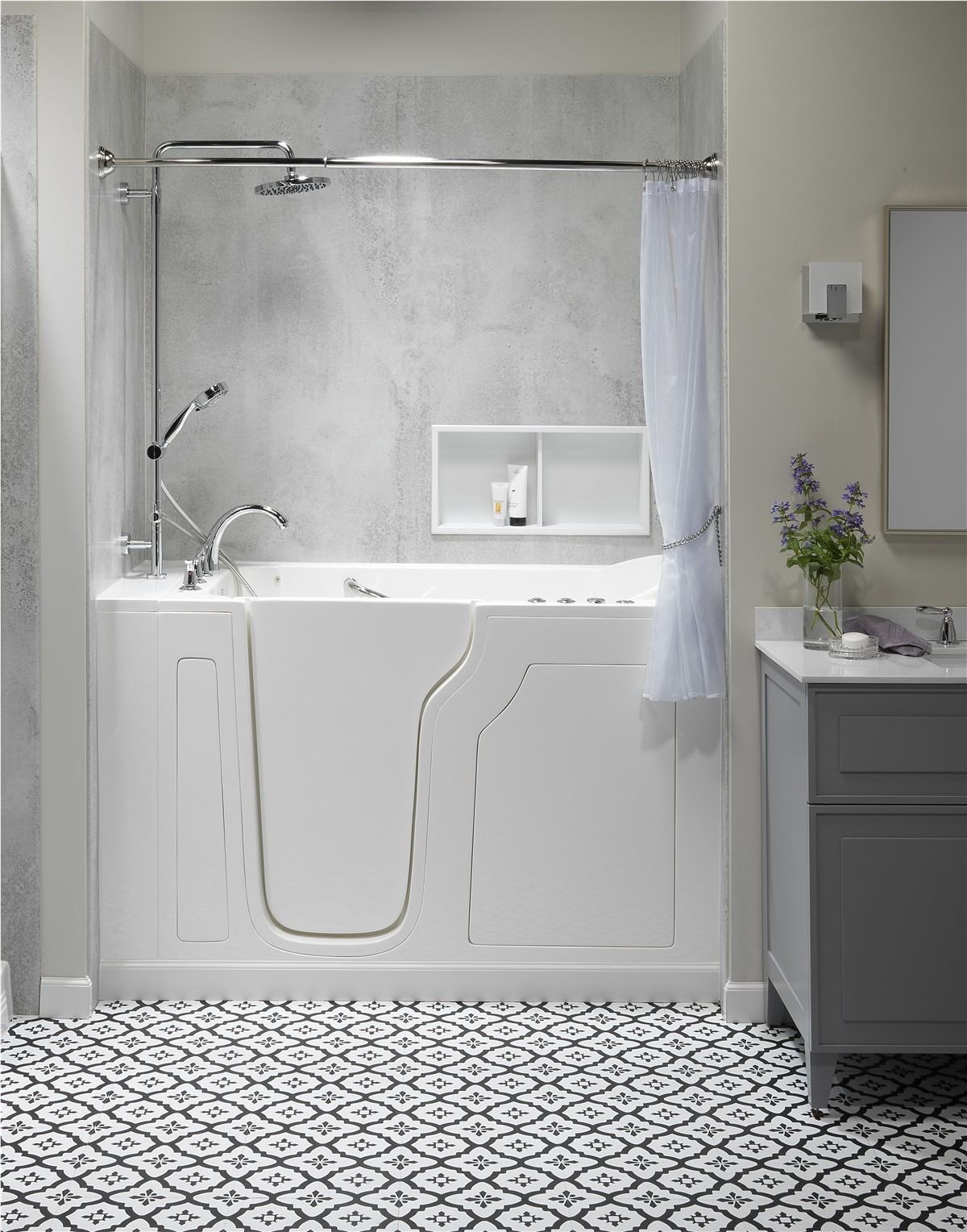 Modern white bathroom with walk-in tub, patterned tile floor, and gray vanity on the right