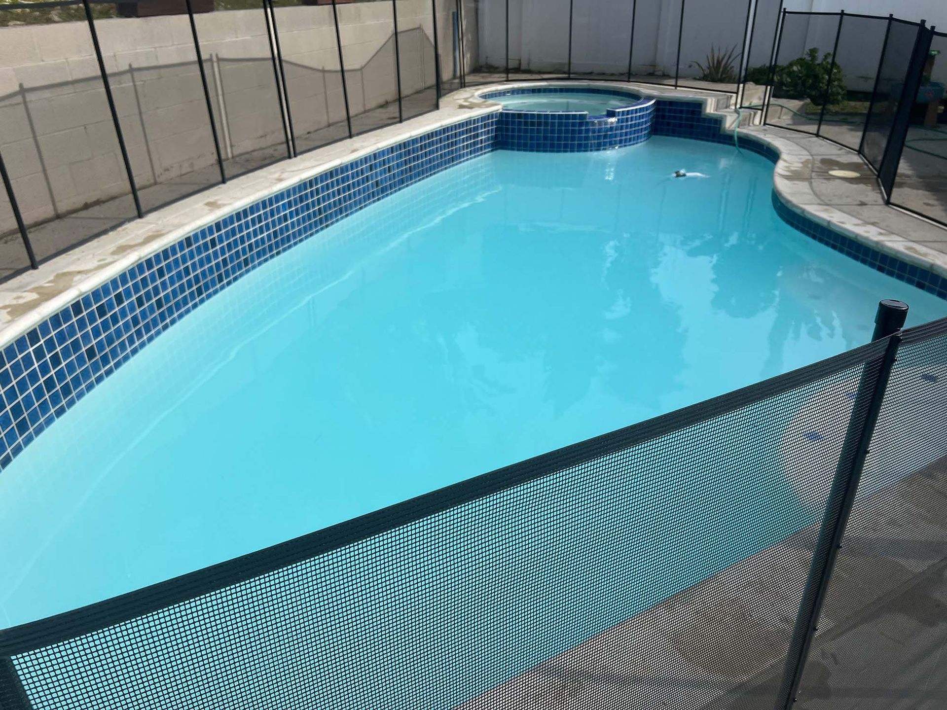 A large swimming pool with a fence around it.