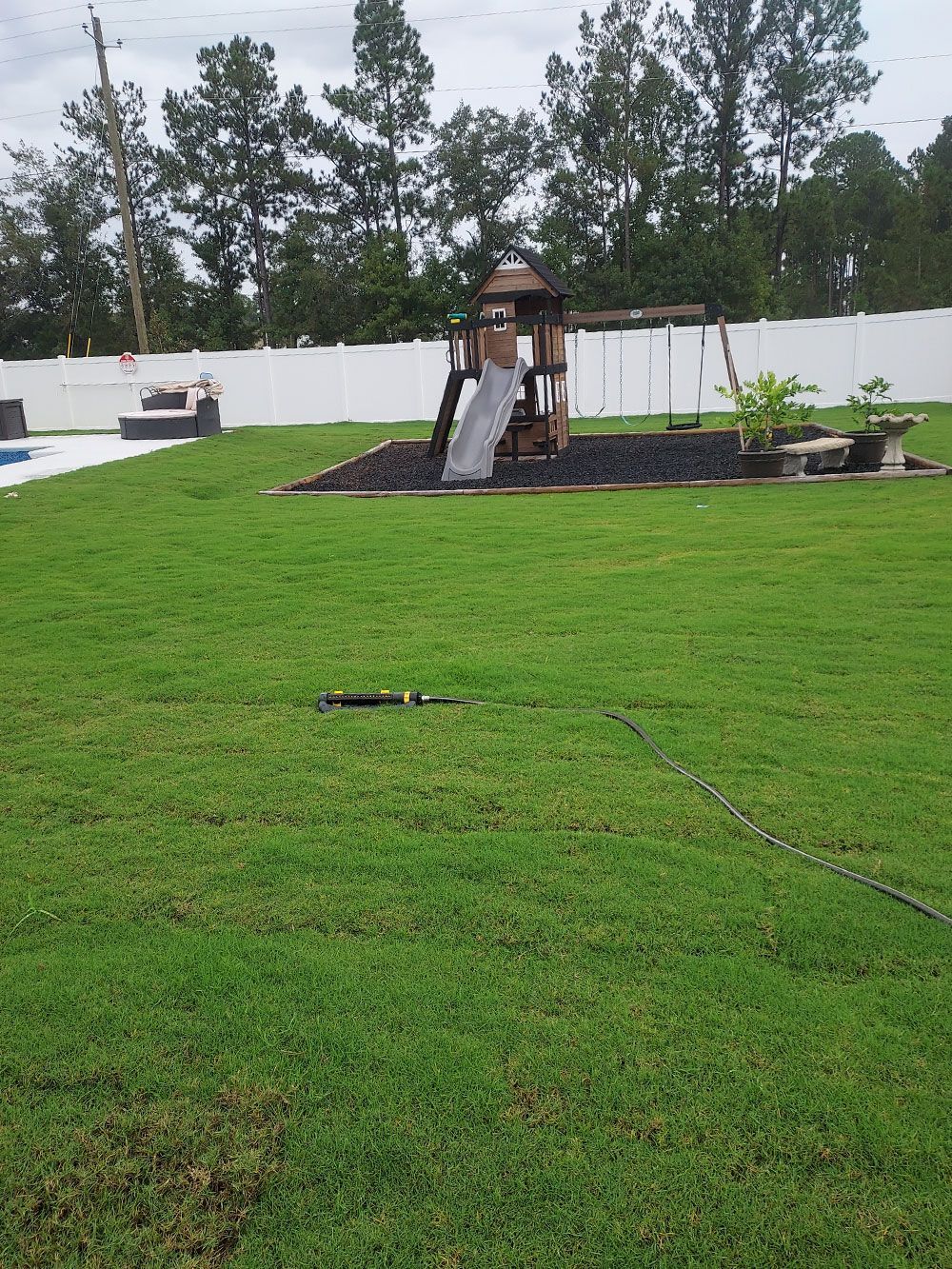 There is a playground in the backyard with a slide.