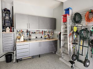 A garage filled with lots of tools and a ladder.