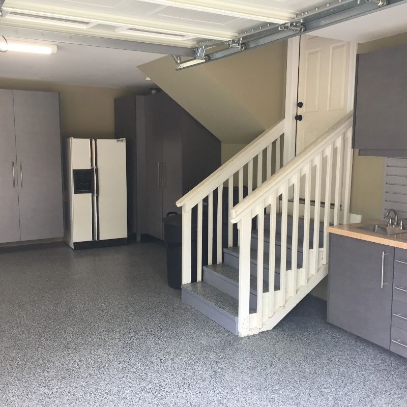 A garage with stairs leading up to the second floor