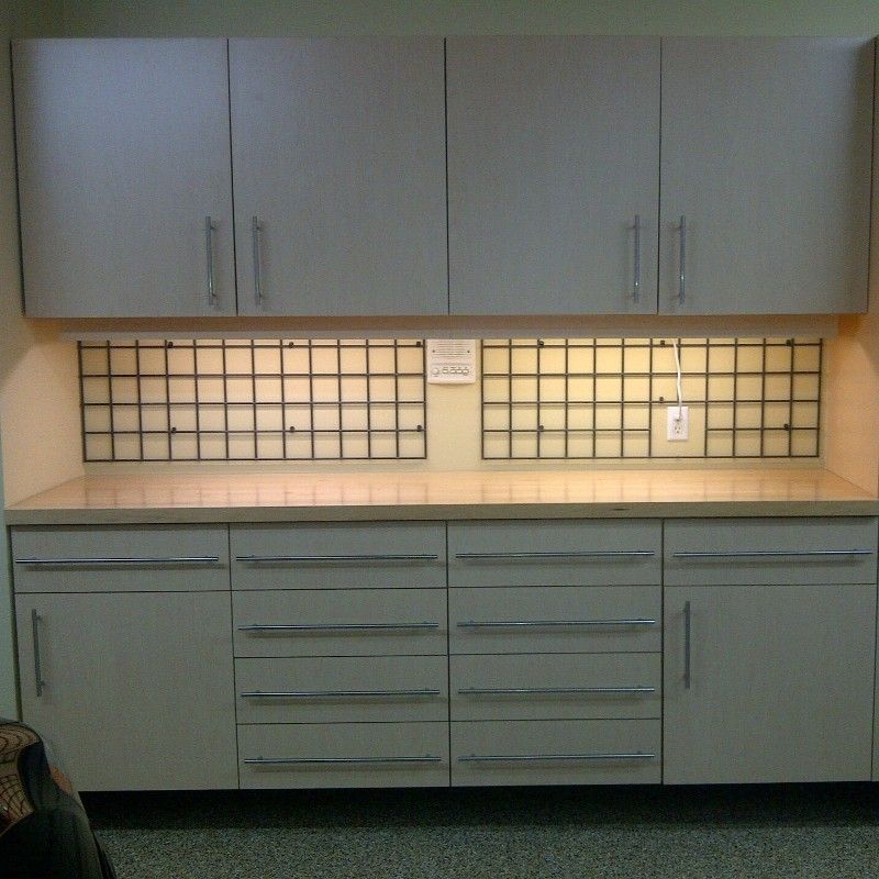 A kitchen with lots of white cabinets and drawers