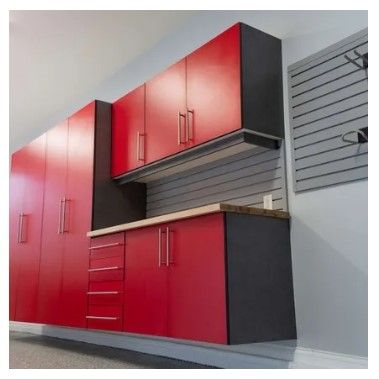A kitchen with red cabinets and black drawers