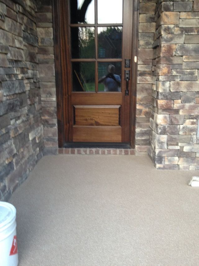 A wooden door with a brick wall behind it