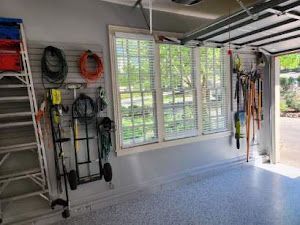 A garage filled with lots of tools and a ladder.