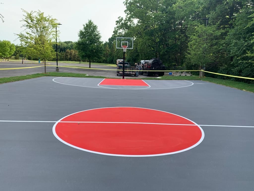 A basketball court with a red circle in the middle of it.