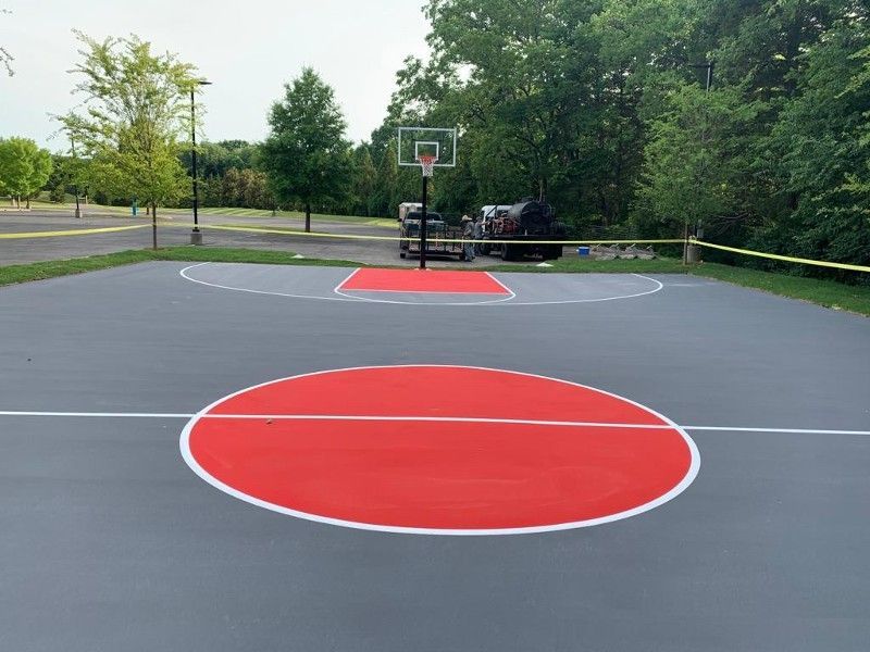 A basketball court with a red circle in the middle